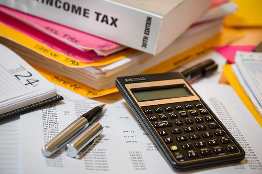 Calculator and tax documents for South African payroll taxes