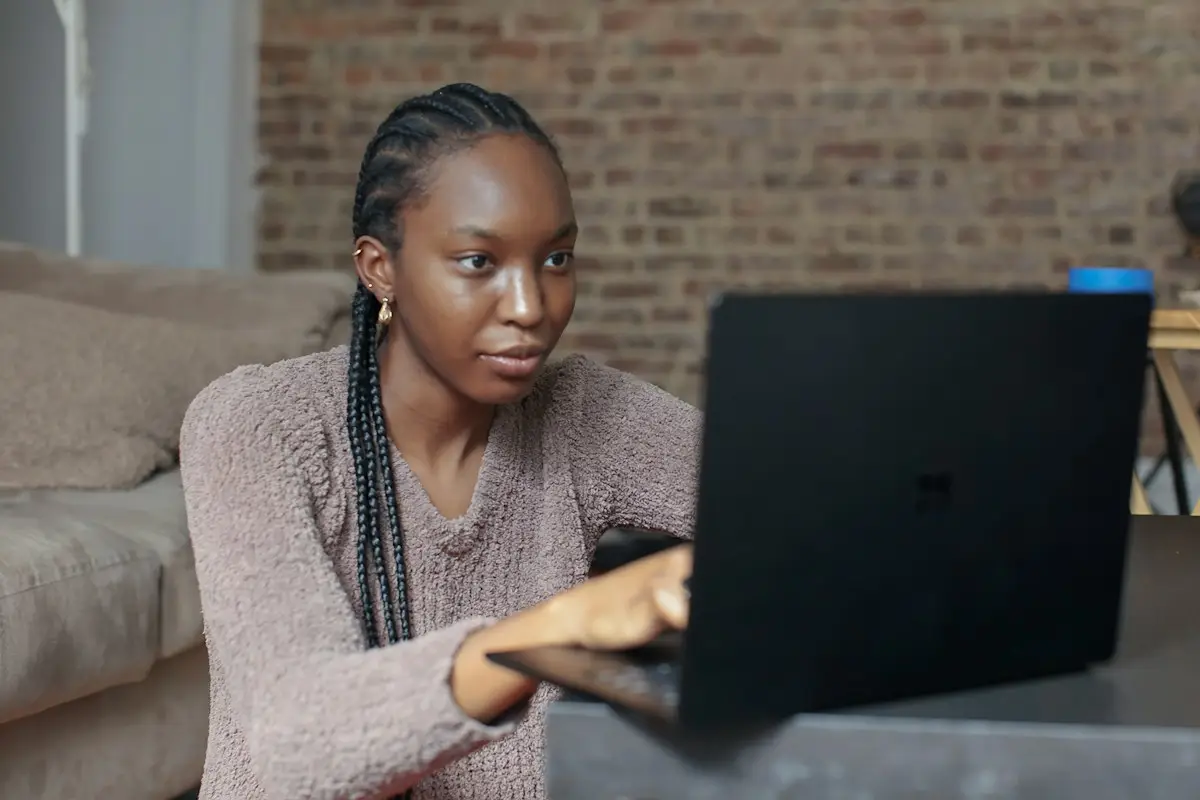 Woman filing her late tax return on a laptop at home